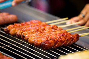skewers of golden and tempting grilled sausages are neatly arranged