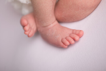 Little human newborn baby feet details close up