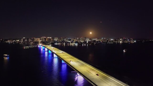Drone of downtown Sarasota Florida at night over Ringling Causeway Bridge