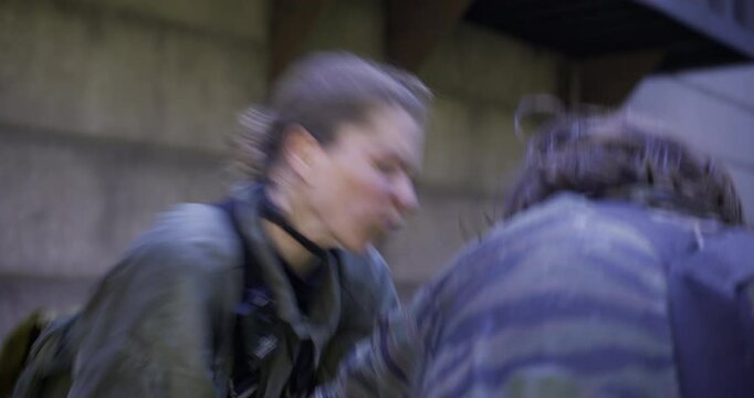 Female solider wrestling then overpowering man by stabbing him with his own knife - steady cam movement