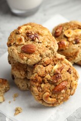 Tasty cookies with nuts on table, closeup
