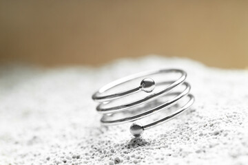 Beautiful silver ring on stone surface, closeup. Space for text