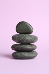Stack of rocks on lilac background. Harmony and life balance
