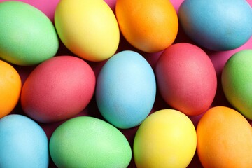Beautiful decorated Easter eggs on pink background, flat lay