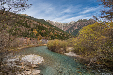 Nature landscape at Kamikochi Japan of autumn foliage with pond and mountain