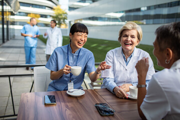 Group of female doctors discussing medical topics outdoors