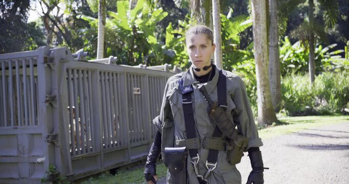 Epic shot of female soldier staring at something, dropping case then jumping into action