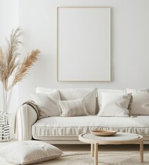 A white couch with pillows and a throw blanket sits in front of a large. empty picture frame in a minimalist living room