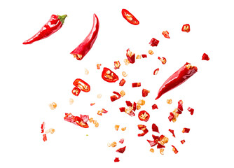 Scattered sliced red chili peppers with seeds and chopped pieces on a transparent background, fiery spice ingredient, dynamic food composition for culinary and seasoning designs