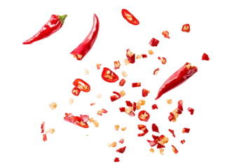 Scattered sliced red chili peppers with seeds and chopped pieces on a transparent background, fiery spice ingredient, dynamic food composition for culinary and seasoning designs