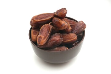Bowl full of pitted dates isolated on white background