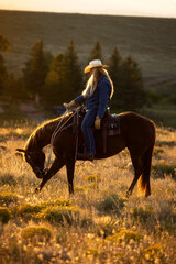 Colorado Cowgirl riding in Mountain ranch on Quarter Horse