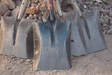 Various shovels displayed on the ground in a construction area