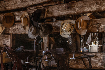 Cowboy hats on wall in rustic tack room