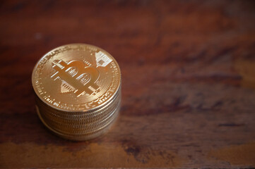 Bitcoin tokens on wooden table. Cryptocurrency is a virtual or digital money which takes the form of tokens or “coins” it can be used to buy goods and services.