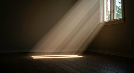 Obraz premium The Beam of Hope: Sunlight streams dramatically through a window, illuminating a room with a play of light and shadow, creating a sense of serenity and introspection.