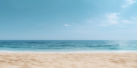 Obraz premium An expansive view of a serene beach with soft sands and a crystal-clear blue sky, inviting relaxation and tranquility, making it an ideal destination for sunbathing or meditation.