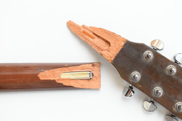part of broken wood acoustic guitar isolated on white background
