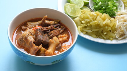rice vermicelli with northern thai curry sauce on blue background