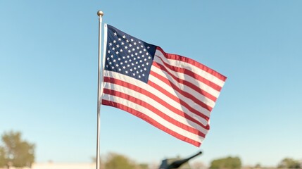 Obraz premium american flag waves gently in breeze prominently displayed against clear blue sky its vibrant reds whites and blues