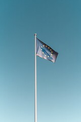 Fototapeta premium celebrate europe day with minimalist shot featuring flag of european union fluttering gracefully against clear blue