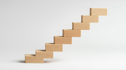 Wooden blocks arranged as ascending staircase on white background, symbolizing business growth, success, progress, development, career steps, and future opportunities.