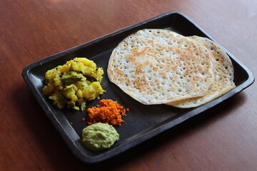 Set Dosa, soft, light and spongy dosa, served with potato subji, coconut green chutney and peanut...