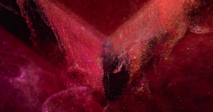 Glitter paint wave. Defocused emulsion. Bright orange red color oil sequin metal dust particles water glass cube abstract art background.