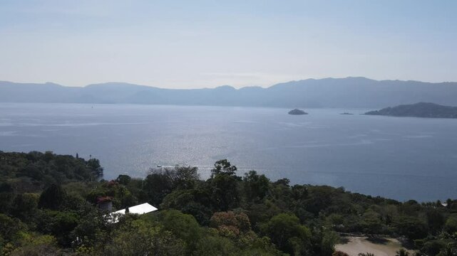 Views of the beautiful Ilopango Lake in El Salvador, with mountains and volcanoes around during the summer