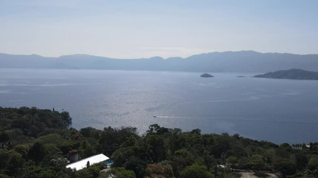 Views of the beautiful Ilopango Lake in El Salvador, with mountains and volcanoes around during the summer
