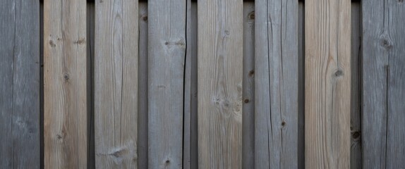 Fototapeta premium Weathered gray wooden fence planks texture close up showcasing varying shades and grain patterns perfect for rustic or contemporary designs.