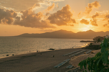 Sunset on the tourist beach of Playa Blanca on the island of Lanzarote in Spain.