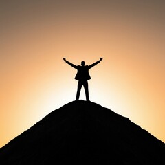 Silhouette of a Man on a Mountain at Sunset