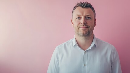 Confident Businessman Posing Against a Soft Pink Background for Professional Portraits