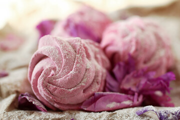 Perfect dessert - delightful homemade pink berry marshmallows served sugar powder and purple flowers