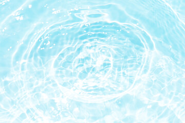 Blue water with ripples on the surface. Defocus blurred transparent blue colored clear calm water surface texture with splashes and bubbles. Water waves with shining pattern texture background.