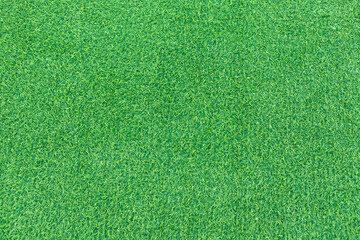 Close-up of lush green artificial grass, showcasing its detailed texture and vibrant color, perfect...