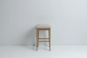 Bar stool with upholstered backless seat in an empty white room on a gray background.