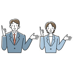 指をさして説明するスーツ姿の女性と男性