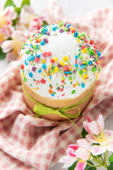 Delicious easter cake decorated with colorful sprinkles and spring flowers