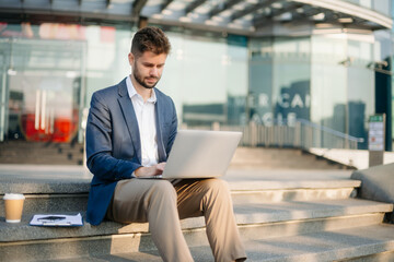 Modern businessman outdoors, using a tablet. Ideal for business, technology, and innovation themes.