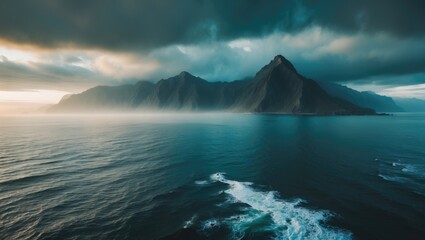 Aerial view portraying an ocean scene with mountains and clouds visible in the distance.