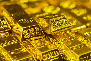 Stacking gold bars with golden light. Gold is hard commodity goods, risk asset, tangible value that used to be gold reserve, save assets during war and economic crisis