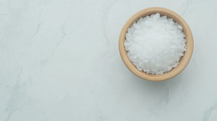 Salt Bowl Close-up: A rustic wooden bowl filled with coarse sea salt sits on a stone surface, inviting a sensory experience with its texture and the subtle warmth of the wood