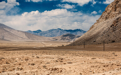 A desert landscape with a mountain in the background