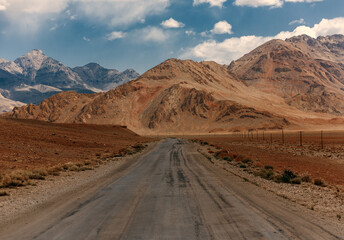 A road in the desert with mountains in the background