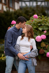 Young Cute Female Hugs Boyfriend. In Autumn Outdoor. Lovers Walking in Park. Attractive Funny Couple. Lovestory in Forest. Man and Woman. Cute Lovers in the Park. Family Concept. Happy Couple.