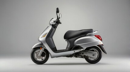 Silver Scooter with Sleek Black Seat Displayed in a Side View on Gray Background