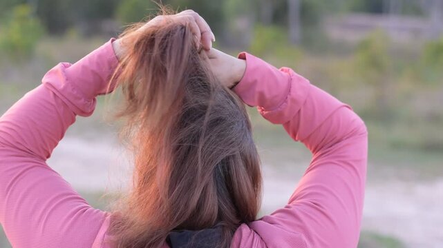 Asian woman's gray hair, Grey color hair of Asian, Regrown gray roots of dyed hair on head of woman, Dry and damaged hair