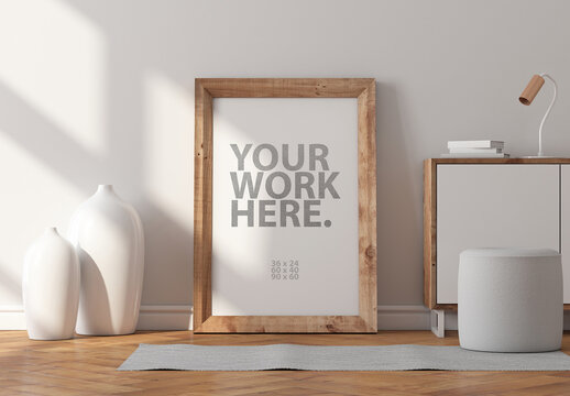 Vertical poster art with wooden frame mockup standing on the parquet